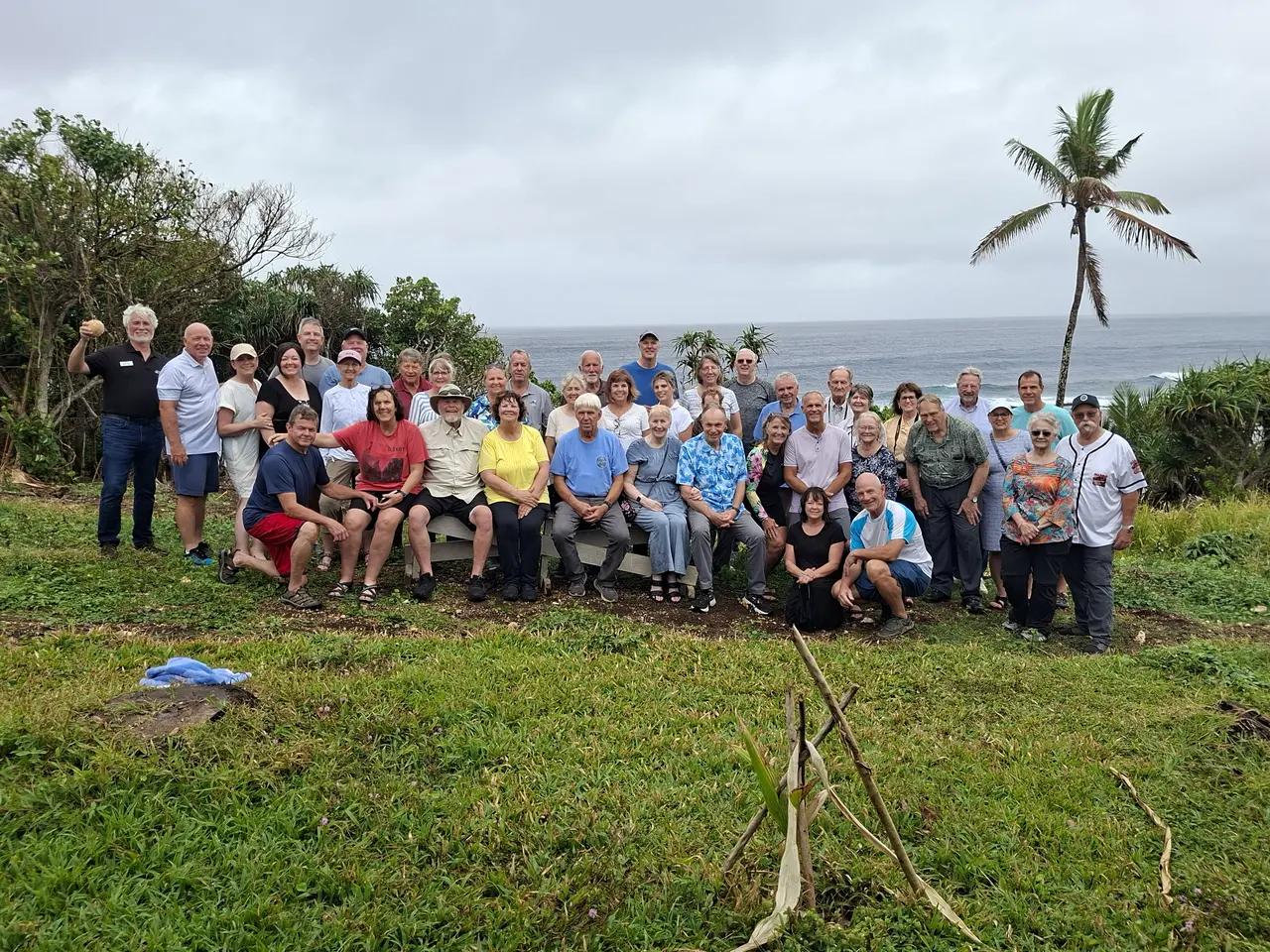 A group of tour guests gathered at a scenic Tongatapu coastal stop